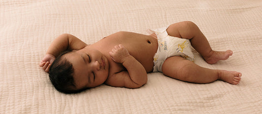 Un bébé endormi sur un lit.
